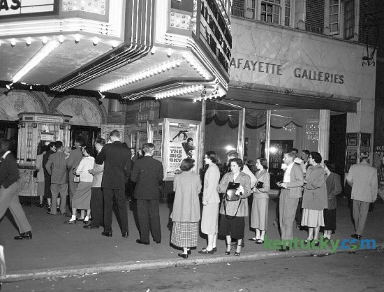 Photo showing patrons lining up to watch a movie at the Kentucky Theatre in October 1952. One of the movies playing was The Big Sky, an American Western film directed by Howard Hawks, based on the novel of the same name. The cast included Kirk Douglas, Arthur Hunnicutt, Dewey Martin and Elizabeth Threatt.  Published in the Herald-Leader October 13, 1952. Herald-Leader Archive Photo