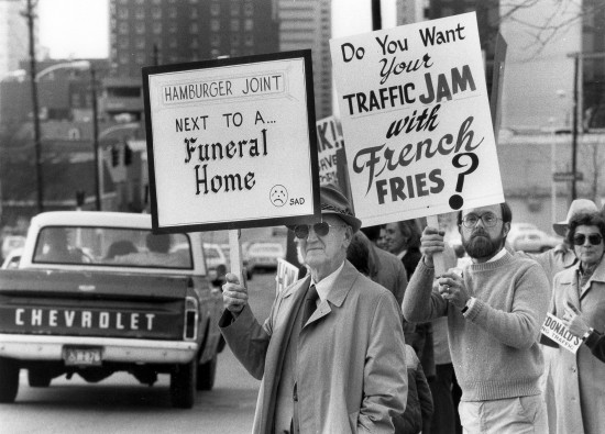 A group including Lon Rogers, left, held up signs as they protested the building of a new McDonalds at 473 Main St. near Forest Ave. in Lexington, Ky., on April 4, 1983. The restaurant ended up being built but without a drive-thru window. McDonalds later moved to another location and Cielito Lindo Mexican restaurant moved into the old building. The building was torn down a few years ago. Photo by Charles Bertram | Staff