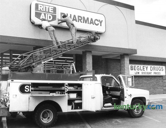 Red McDaniel and Paul Fletcher, employees of Smithers Sign Co., put up a new Rite Aid Pharmacy sign April 28, 1988 on the former Begley drugstore in Imperial Shopping Center on Waller Avenue in Lexington. Rite Aid, at the time the nation’s largest drugstore company, bought Begley’s for $18.5 million in 1988. It won a nine-week takeover battle against SupeRx of Arizona, Georgia and Alabama Corp. Begley, which was based in Richmond had 43 drugstores in Kentucky and 140 dry-cleaning outlets in 10 states under the name Big B One Hour Cleaners. The Begley Co. once employed 1,400 people. Photo by Michael Malone | staff