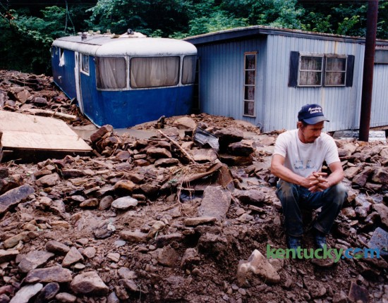 Billy Ray Hubbard sat in silence July 25, 1992 on tons of rubble that had washed down around his mobile home during a flash flood on Bear Creek in Clay County. The small blue and white trailer, where his son and daughter-in-law lived, was swept 50 feet in the flood and came to rest against his home. Photo by Tom Marks | Staff