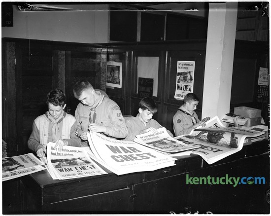 Members of Boy Scout Troop 21 count posters advertising the War Chest Drive during WWII, Oct. 9, 1944. The posters were delivered to downtown business firms.  Pictured from left to right are Fant Martin, Marion Tabb, Billy Hinkle, and George Bolner.  Boy Scouts helping with War Chest drive, October 9, 1944.  The Boy Scouts are counting posters which advertise the War Chest Drive.  The posters were delivered to downtown business firms.  Pictured from left to right are Fant Martin, Marion Tabb, Billy Hinkle, and George Bolner.  They are members of Troop 21. Published in the Lexington Herald October 10, 1944. Herald-Leader Archive Photo
