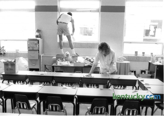 First grade teacher Paige Thornton, right, prepared desks for the first day of school at Squires Elementary School on August 20, 1988. Anthony King of King & Queen's Cleaning Service worked on the classroom's windows. Photo by Tom Woods II | Staff