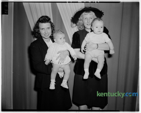 Pictured are Mrs. Dorothy Ryan, with her nephew, Jerry Fryman, who won first place in the "up to one year old" baby contest held in connection with the 1946 Bourbon County Fall Festival. At left are Mrs. Arthur Peters and her daughter, Linda Jean, who won second place in the contest. Published in the Lexington Herald October 10, 1946. Herald-Leader Archive Photo