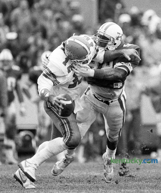 The University of Kentucky's Carwell Gardner sacks Florida's Kerwin Bell during UK's 10-3 victory over the University of Florida on Nov. 15, 1986 at Commonwealth Stadium in Lexington. The win snapped a six-game losing streak against the Gators. Unfortunately for Kentucky, the Cats have not beaten Florida since that game, suffering 28 straight losses to the Gators. Photo by Charles Bertram | staff