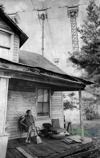 Mildred Edmonds, a resident of Little Georgetown, sat on her front porch beneath approach light towers of then Blue Grass Field, in August 1978. Her house sat on the south side of Parker's Mill Road across from the end of the main runway.  Little Georgetown originated in the nineteenth century after the Civil War on land that had been part of a farm belonging to George Waltz. The community may be named for him or for freed slave George Washington who subdivided some land he owned there in 1877. It once had a school and about 90 residents, but as the airport expanded many residents left the area and others who were directly in the path of the runway were given money by the airport to relocate. Photo by John C. Wyatt | Staff