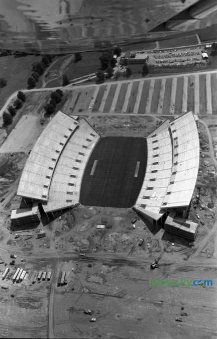 Aerial photo of what would be named Commonwealth Stadium, at the Univeristy of Kentucky, in mid August 1973. When construction was completed in September 1973, Commonwealth Stadium had a capacity of 57,800. It was built  at a cost of $12 million by the firm of Huber, Hunt, and Nichols. The stadium and parking areas rest on an 86-acre plot that was once part of the UK Experimental Station Farm Grounds. The stadium was officially opened on Sept. 15, 1973, as the Wildcats moved into their new home after spending 48 years at Stoll Field/McLean Stadium across from Memorial Coliseum. Kentucky defeated Virginia Tech in the stadium opener, 31-26, as quarterback Ernie Lewis ran for two touchdowns and threw for another TD to lead the Wildcats. Herald-Leader Archive Photo Aerial of CWS, 8/19/73