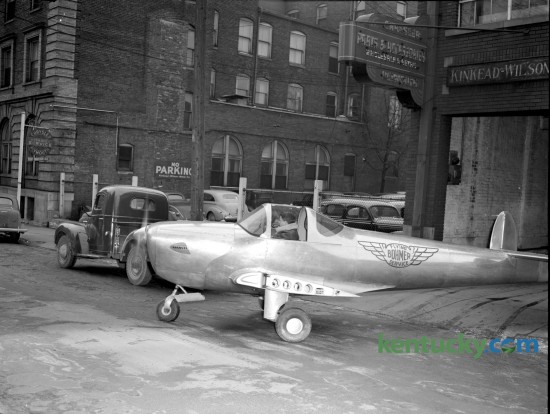 Charles Bohmer, of Bohmer Flying Service, drove his Ercoupe back to Blue Grass Field on February 25, 1947, after a month's display in Kinkead-Wilson Motor Company showrooms, 177 North Mill Street in downtown Lexington. Shorn of it's wings and throttled back to 45 miles and hour the single engine plane navigated city streets and Versailles Pike under its own power without incident. The plane was escorted by city and county patrolmen to the airport. Herald-Leader Archive Photo
