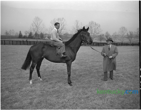 In January 1951 British jockey Harry Carr posed for a photo on Prince Simon who was being held by A.B. Hancock, Jr. At that time Carr was the King's jockey, having been appointed in 1946. He retired from racing in 1964 after having won 1,363 winners. Published in the Lexington Herald January 13, 1951. Herald-Leader Archive Photo