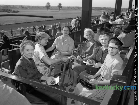 A group of ladies joined Rebecca Edwards in her box during Keeneland's Fall Meet in October 1954. Pictured are Ruth Dudley Williams of Frankfort, Nell Dishman of Frankfort, Miss Edwards, Jane Melton of Frankfort,  Manila Lyman of Lexington, and Mrs. L. L. Essenbock of Lexington. Published in the Lexington Leader October 14, 1954. Herald-Leader Archive Photo