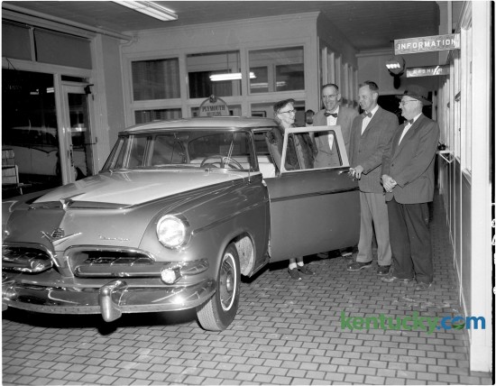 Mr. and Mrs. J. V. Ewan of  Cooper Drive in Lexington bought their 13th Dodge automobile from Goodwin Brothers, Inc., December 21, 1954. Shown with their latest automobile, from left,  are Mrs. Ewan, principal of the Kenwick School; Reid B. Bishop, car salesman; William Goodwin, president of the auto firm and J.V. Ewan. Goodwin Brothers, Inc. sold Plymouth and Dodge automobiles and trucks and was located at 450 E. Main Street. Published in the Lexington Herald December 22, 1954. Herald-Leader Archive Photo