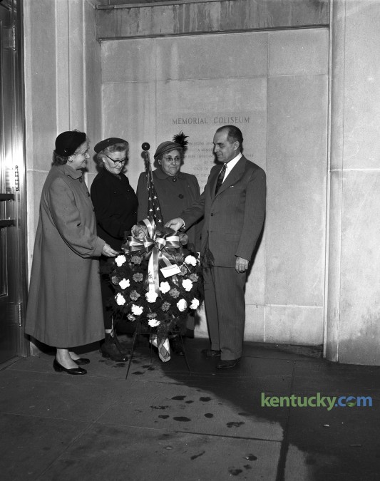 The Lexington chapter of the American War Mothers observed the 10th anniversary of the bombing of Pearl Harbor by placing a wreath in the lobby of Memorial Coliseum in December 1951.  Pictured are (left to right) Mrs. Thurman Hagan, Mrs. L.H. Horlacher, Mrs. J.S. Carpenter, and Bart N. Peak, guest speaker at the ceremony. Published in the Lexington Leader December 7, 1951. Herald-Leader Archive Photo