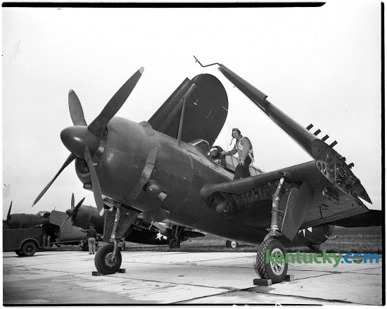 Lieutenant John Mason, United States Naval Reserve, is shown climbing into his plane, an SB2C Helldiver, Oct. 22 1945 at Blue Grass Field in Lexington, where he and other members of the Navy Victory squadron presented an exhibition. 20 Naval planes flew a "Navy Flying Might" air show as part of Fayette County's Vickty War Bond campaign. The insignia on the plane show that Lieutenant Mason destroyed three Japanese planes on the ground, sank two ships (a destroyer and a freighter-transport) and participated in 30 bombing missions. Published in the Lexington Leader October 23, 1945. Herald-Leader Archive Photo