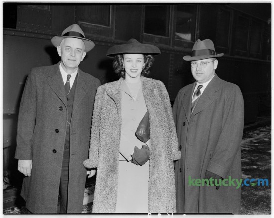Miss Venus Ramey, native Kentuckian and Miss America for 1944, pictured during brief stop in Lexington.  Left, Miss Ramey's father, J.C. Ramey, of Waynesburg.  Right, Miss Ramey's brother, J.W. Ramey. Ramey was born September 26, 1924 in Ashland, Ky. She left the state to work for the war effort in Washington, DC, and won the Miss District of Columbia pageant and then became Miss America in 1944. She was the first red-haired contestant to win the title. In 2007, on her farm in Lincoln County, the then 82-year-old used a .38-caliber handgun to shoot out the tires of a car belonging to an intrucer, while balancing on her walker. She held the man until police arrived. She later appeared on The Tonight Show with Jay Leno, who aked her where she learned to shoot. "I'm from Kentucky," she replied. Published in the Lexington Herald December 1, 1944. Herald-Leader Archive Photo