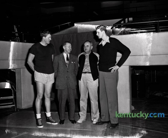 Two of the nation's top basketball programs, head coaches and big men posed for a picture the day before the University of Kentucky played Kansas in Memorial Coliseum in December 1950. From left, are Clyde Lovellette, 6-9 Kansas University center, Kansas  Coach Phog Allen, Kentucky Coach Adolph Rupp and Bill Spivey, 7-foot Kentucky  center. The quartet got together December 15, 1950 at Memorial Coliseum where both the Jayhawks and Wildcats worked out prior to their game December 16, 1950. UK dominated KU and won 68-39. Herald-Leader Archive Photo