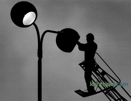 Paul Fletcher worked from a ladder truck to replace a high intensity light bulb on one of the parking lot lights at Hardees Restaurant on the Avenue of Champions on January 20, 1986. Fletcher worked for the Smithers Sign Company. Papa John's Pizza now occupies the space where Hardee's was located. Photo by Charles Bertram | Staff