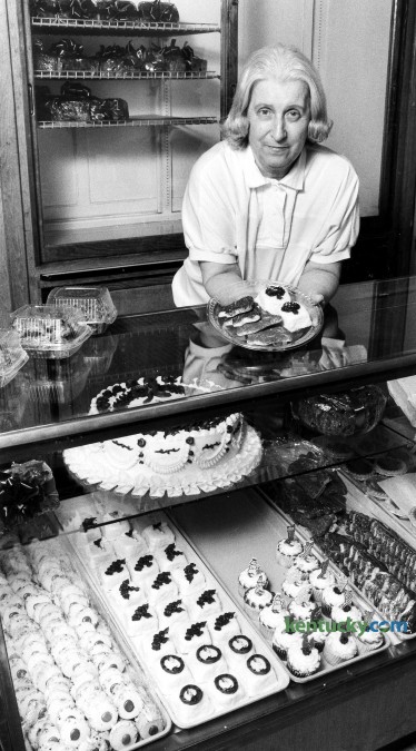 Joyce Higgins, owner of Magee's Bakery with her husband, Ralph, displays some Christmas cookies and pettifores Dec. 6, 1990 that are being baked now for the holidays. Her cases are filled with many other homemade treeats. Phot by Jennifer Podis | staff