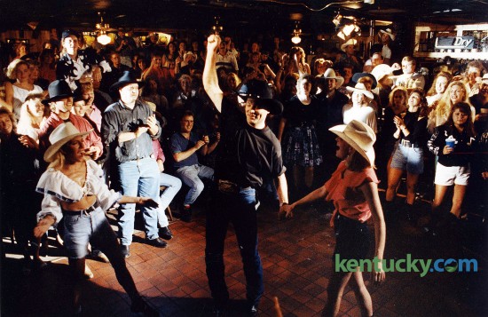 Lexington country singer John Michael Montgomery during the making of a music video at Austin City Saloon in Woodhill Center in Lexington, June, 3, 1993. Montgomery, who played in the bar for more than five years before he got his big break in Nashville, was filming the video for his song "Beer and Bones." The honky- tonk-style tune was Montgomery's third single from his national album debut, Life's a Dance. "I'm just enjoying what's happening to me as much as I can," Montgomery said during a break in filming. "The funniest thing for me is to take it back to the people and bring everything back here to where it started." Photo by Frank Anderson | staff