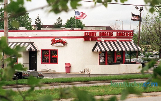 Kenny Rogers Roasters in Patchen Village on Richmond Road, May 12, 1996. The chicken restaurant chain was founded in 1991 by musician Kenny Rogers and former governor of Kentucky, John Y. Brown Jr. The chain grew to 350 locations world-wide and was even featured in a popular episode of the T.V. show Seinfeld. In 1998 the company filed for bankruptcy and closed many of it's restaurants. Lexington's two locations - the other in Turfland Mall - closed in early 1999. Today the Richmond Road site in this photo is now a Rite Aid drugstore. There are some locations still open in Asia. Photo by Drew Fritz