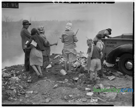 In May of 1940 The Sunday Herald-Leader carried a story about the daily scavengers who desended on Lexington's city dump, on Old Frankfort Pike, hoping to find anything of value that they could sell or use themselves. This photo was an outtake from that story and shows a group going through a freshly unloaded pile of trash. The article noted that the scavengers lived in shanties which dotted Manchester, Driscoll, deRoode, Perry, Jane and adjoining streets. They tended to arrive about mid-afternoon each day and usually left by dark. If an individual earned a dollar a week they considered themselves lucky. The story ran May 19, 1940. Herald-Leader Archive Photo