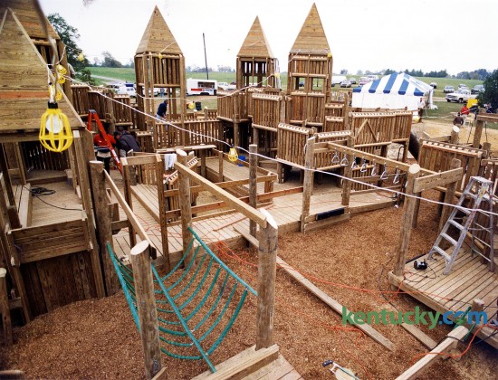Construction of the wooden playground structure at Jacobson Park in Lexington, Oct. 11, 1993. The popular mazelike playground at the Richmond Road park was Lexington's third creative playground. Picadome Elementary School playground was the first -- followed by the Shillito Park project. About 2,500 volunteers contributed toi the completion of the playground. When it opened about two weeks later, it was the largest iplayground n Kentucky, featuring 30,000 square feet of slides, swings, turrets, bridges and hiding nooks. Photo by Mark Cornelison | staff
