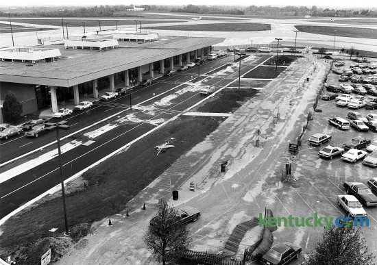 A $1.5 million project to repair deteriorated roads at Blue Grass Airport was nearing completion on Oct. 15 1985. The airports roads had deteriorated because of increased traffic volume, airport executive director Jim Brough said at the time. The improvements included rebuilding the entrance road to the airport, incorporating curbing and gutters with storm sewers, building a four-lane divided road leading into the airport, adding an interior circulation loop to the terminal, and improving intersection designs. Less than two years later, in September 1998, ground was broken on a $12 million expansion to double the size of the terminal that included new elevators and escalators, a restaurant and a third-level observation room. The first level of a $12 million, three-level parking garage opened more than 10 years later, in July 1999, in the area shown on the right side of the photo. The two upper levels, which were for long-term parking, opened the following October. The garage added more than 700 parking spaces, from fewer than 1,200 to nearly 2,000. Photo by Ron Garrison | Staff