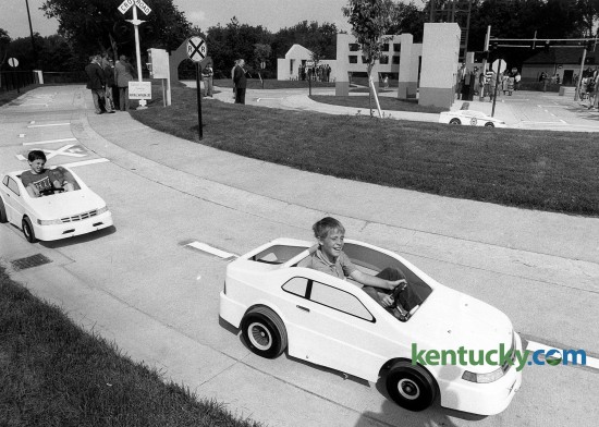 The opening of Safety City, Lexington’s make-believe city that teaches children about automobile and pedestrian safety, May 23, 1990. The community project includes a network of two-lane streets that is realistic in detail, with curbs, sidewalks and pedestrian crossings. More than 2,000 children from Central Kentucky visit Safety City each school year. The city is a partnership between Eastern Kentucky University and the Lexington Police Department. A new fleet of electric cars was recently purchased with the help of a $49,000 donation from Toyota, replaced an aging fleet that had dated back to Safety City’s opening in 1990. Photo by Stephen Castleberry | staff