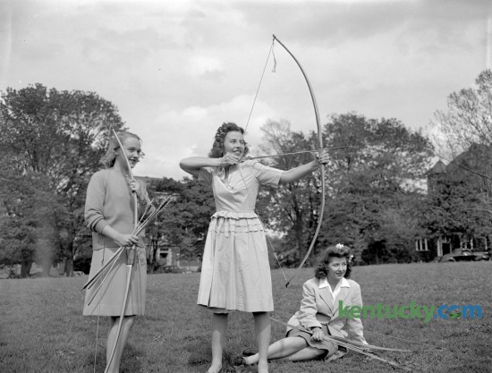 Three University of Kentucky co-eds practiced archery on campus in May of 1944. From left are Miss Elizabeth Carey, Miss Carolyn Gilson and Miss Anne Smith. Published in the Lexington Leader May 6, 1944. Herald-Leader Archive Photo
