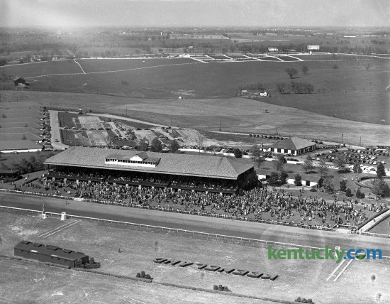 An aerial view of the second day of the 1946 Keeneland Spring Meet, April 12, 1946. 6,000 people were in attendance at the track. The parking lot can bee seen behind the grandstand. The 11-day Spring Meet was capped off with the 22nd running of the Blue Grass Stakes that features a $12,500 purse. General admission to the track was $1.00 for men and $.50 for women. Published in the Lexington Herald, April 13, 1946. Photo by E. Martin Jessee | staff