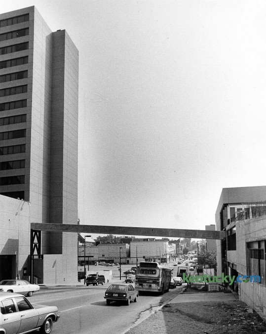 Construction of the skyway crossing South Broadway in downtown Lexington, connecting the Hyatt Regency, shown at left, and Kincaid Towers, July, 1979. The concrete span, first in a series of skyways over downtown, is 100 feet long and nine feet wide. It is about 30 feet above South Broadway at its mid-point. The $100,000 project would wrap up with a lerge covering of aluminum and Plexiglas and opened when Kincaid Towers construction was completed later in the fall of 1979. The photo was taken looking east down South Broadway. In the background, just above the bus is what is now The Square. To the left of the bus is a parking lot which would later become Triangle Park. Photo by Frank Anderson | staff