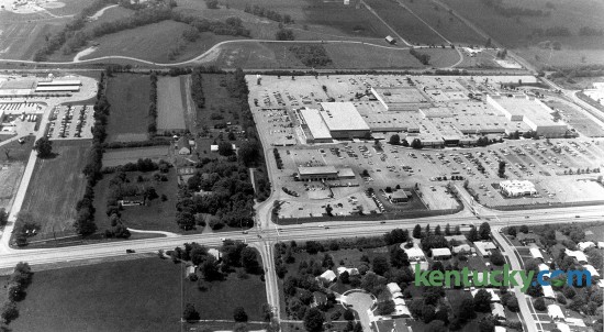An aerial view of Fayette Mall, May 13, 1985. Nicholasville Road runs from left to right across the bottom. The left side of the mall at this time was a Sears store, one of the anchors of the shopping center. In May 1993, the mall expaned, adding nearly two dozen merchants in a new south wing, in the area to the left of Sears in the picture. The expansion made it the Kentucky's largest mall. In 2006, The Plaza at Fayette Mall, a shopping center with a Cinemark Theatres and restaurants, opened in the area on the far left side of the photo. Across the top of the picture is Shillito Park. The park's pool, whcih opened in the summer of 1988, is located just to the left of the curve in the road. Photo by Nick Nickerson | staff