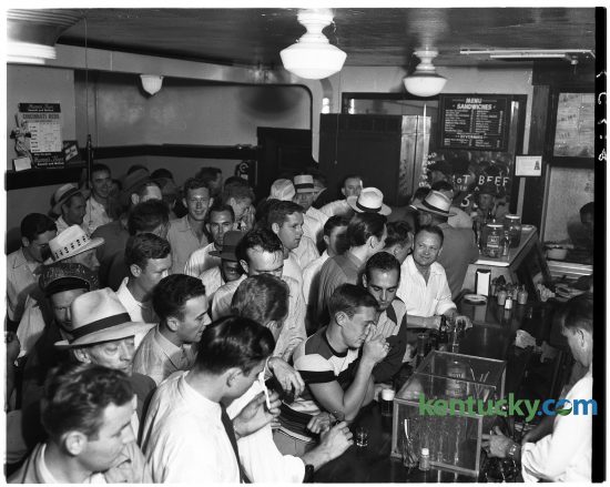For a couple of hours on June 14, 1949, Fisher's Bar, 105 North Limestone Street, was jammed packed with patrons. The reason? Nickel been and whiskey and five-cent sandwiches. Nearly 600 male customers were served from 2-4 p.m. and the scene in the picture shows only about half of the crowd. Popular brand blended and bonded whiskey's and beer and a variety of sandwiches sold for five cents. George West, the bar's owner said, "The drinks and eats are on the house - almost." The bar is not the location of Sam's Hot Dog Stand. Published in the Lexington Herald June 15, 1949. Herald-Leader Archive Photo    Crowd in Fischer's (cq) Lunch (cq) during five-cent sale. George West is operator of bar. Published in the Lexington Herald June 15, 1949. Herald-Leader Archive Photo