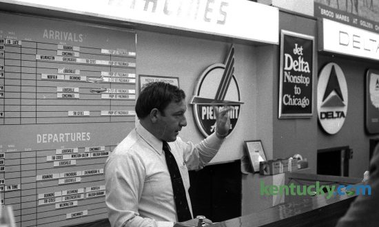 Bill Heflin, working the Piedmont Airlines ticket counter at Blue Grass Field, Dec. 9, 1974. At the time of this photo there were four major airlines that flew out of Lexington: Allegheny, Delta, Eastern and Piedmont. Looking at the arrivals and departure board behind him, the airline had service to and from Lexington to such cities as Greensboro, N.C., Norfolk, Va., Louisville and Cincinnati. Photo by Frank Anderson | staff. Published in the Lexington Herald, Dec. 10, 1974