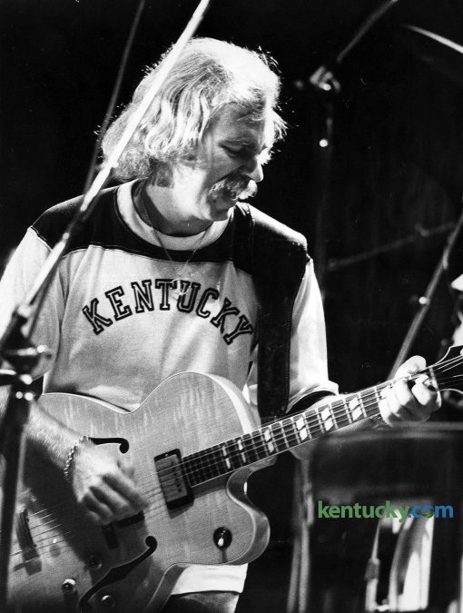 Musician Jimmy Buffett performs at the University of Kentucky's Memorial Coliseum, Sept. 30, 1977. The musician is known for his "island escapism" lifestyle tune and he has a devoted fan base known as "Parrotheads." Together with his Coral Reefer Band, Buffett played before 8,000 for a two-hour set at Memorial. Tickets for the show were $6 and $5. During the show Buffett recalled the first time he played UK. It was at the student center grill and he said he was a young entertainer trying to make ends meet on the "coffeehouse circuit". At the same time Buffett played on the UK campus, country singer Charley Pride performed at Rupp Arena. Photo by Mike Kearney | staff file photo. Published in the Oct. 3, 1977 Lexington Herald