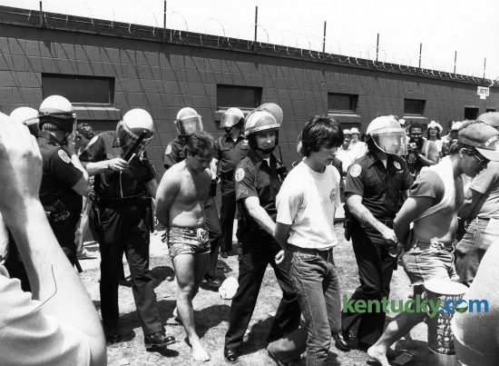 Louisville police officers detain some Kentucky Derby infield patrons May 7, 1983 at Churchill Downs. Many were taken to a holding cell located nearby. Photo by Charles Bertram | staff