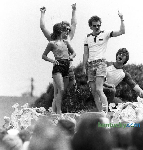 Infield revelers climbed up on a huge white garden urn and encouraged a woman to strip. Across the grounds, women found themselves as instant celebrities as they lifted their shirts to the cheers of many around. Photo by Charles Bertram | staff
