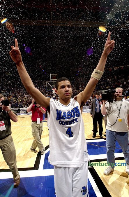 Under a sea of confetti, Mason County guard Chris Lofton shows the Rupp Arena crowd who is number one after the Royals beat Ballard in the finals of the Boys' Sweet Sixteen basketball tournament March 22, 2003 in Lexington. Lofton led Mason County to it's first state basketball title with his tournament Most Valuable Player performance that included a record-tying nine three-pointers in the 86-65 championship game victory. The next year Lofton added Mr. Basketball honors to his resume. He then played college ball at Tennessee where he broke the SEC record for career three-pointers - 431. Currently, he has built a professional career playing basketball overseas. Photo by Marck Cornelison | staff