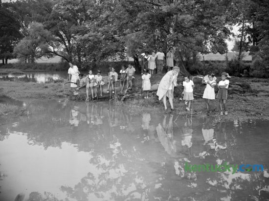 These Brownie Scouts vacationing at the Girl Scouts Day camp on Mt. Brilliant Farm in July 1947 were part of a complement of 35 girls who have been attending an outdoor health and athletic program there for the past two weeks. Guided by nine counselors, the Scouts' program included fishing, hiking, cooking, handicrafts and folk dancing. Counselors in the picture are Mary Caldwell Taylor, far left, and Olive Jean Heckler. Herald-Leader Archive Photo