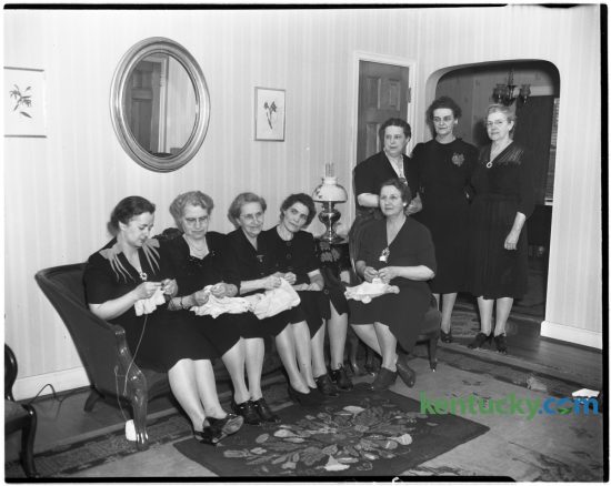 Photograph taken sometime in 1946 of a sewing circle which had met weekly for 18 years.  Mrs. Henry W. Gentry, Mrs. John H. Bowman, Mrs. George W. Tudor, Mrs. William P. Turner, and Mrs. George R. Hukle.  Standing, Mrs. Mae C. Rice, Mrs. Andrew Hamon, hostess, and Mrs. Margaret Marquis. Herald-Leader Archive Photo