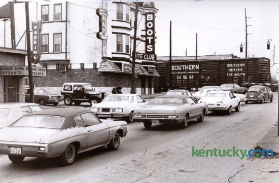 Traffic on South Broadway was frequently delayed by this railroad crossing, as seen in this 1978 photo. After years of study and planning an underpass was built to alleviate the traffic congestion and opened in the fall of 1987. At left next to the tracks is Boots Bar, a popular night club. At extreme left is Coomer's another popular night club. Direct access to both businesses was cut off by the new underpass and this portion of South Broadway became a dead end at the tracks. Photo by Christy Porter | Staff