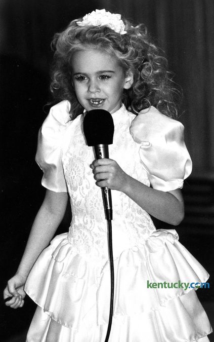 Six-year-old Laura Bell Bundy sings "My Old Kentucky Home" at the beginning of Leukemia Society benefit and fashion show Jan. 23, 1988 in Lexington. Bundy, a Lexington native, is a singer and actress who has performed on Broadway, TV and movies. On Broadway, she is best known for her Tony Award-nominated performance as Elle Woods in the musical version of "Legally Blonde" and originating the role of Amber Von Tussle in "Hairspray." On TV she has played opposite  Charlie Sheen on "Anger Management" on the CW's "Hart of Dixie" and had many guest appearances in shows from "Home Improvement" to "How I Met Your Mother." She has also produced several successful web sketch comedy series. Bundy has appeared in such movies as "Jumanji" and "Dreamgirls." She has also released five country music albums, the most recent in June 2015. Bundy is set to star as Trixie in an all new Broadway musical version of The Honeymooners alongside Hank Azaria, Leslie Kritzer and Michael McGrath. Photo by Alan Lessig