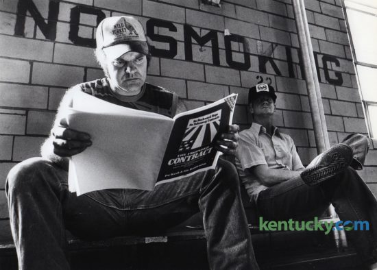 John Hall looked over the new United Mine Workers of America contract in the gymnasium at Cumberland High School in Cumberland, Ky., Tuesday, September 25, 1984. Hall was a member of UMWA Local 7425 and was a miner at the U.S. Steel Mine No. 32. In the background is fellow miner and UMWA member, William Clark. Thousands of active and retired (UMWA) members from seven states are expected to attend a rally in downtown Lexington Tuesday in support of legislation pending in Congress to protect health care and pension benefits for retired coal miners, their dependents and widows. Photo by Charles Bertram | Staff