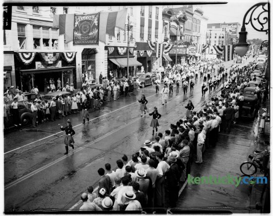 The American Legion and Auxiliary held a parade down Main Street on the eve of their three-day convention on July 7,1946. The parade was led by Man O' War Post No. 8 drum and bugle corps. It originated at Midland and Main Streets and ended at Broadway and drew a large crowd who lined the streets and the courthouse steps, hung from the windows of downtown buildings and perched atop parked automobiles. Lexington's Fourth of July parade will be held Monday and follow the same route down Main St. Herald-Leader Archive Photo