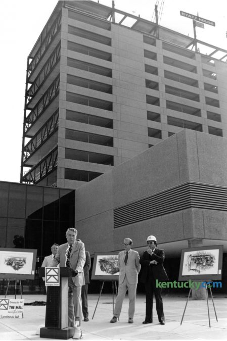 Jake Graves, Lexington Center board chairman, at podium, addressed the media, along with Lexington Mayor Foster Pettit, second from right, and Tom Minter, right, Lexington Center Corporation executive director and general manager, during a hard hat tour of the unfinished civic center on July 20, 1976. Lexington Center, including Rupp Arena, held it's grand opening October 7-10, 1976. The Hyatt House Hotel, later to become the Hyatt Regency Hotel, in the background, was still under construction and would not open until 1977. Herald-Leader Archive Photo