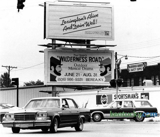 A billboards at the intersection of Winchester Road and Walton Avenue proclaimed "Lexington's Alive and Doin' Well", Aug. 1, 1980. Behind traffic is the Sportsman's Drive-In Liquor store, which is now Locals' Craft Food and Drink. Photo by Ron Garrison | staff