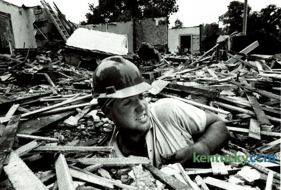 Willis Bastin emerged from the floor of a house he was tearing down on Central Avenue in Lexington on June 26, 1985. Bastin, 23, quit his noon to 8pm job driving a forklift and established his own demolition company, W.N. Bastin Contracting Company. He was razing three houses at 614, 618 and 622 Central Avenue. The Lexington-Fayette County Historic Commission called them "turn-of-the-century T-plan cottages" built between 1895 and 1900. Photo by Ron Garrison | Staff