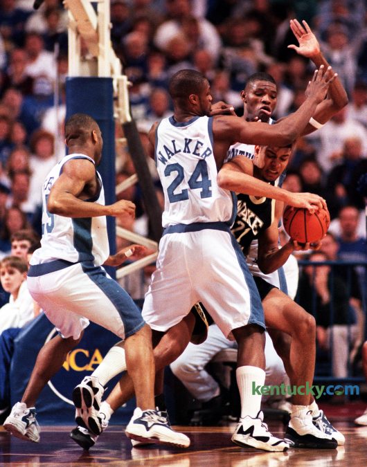 University of Kentucky's Antoine Walker and Walter McCarty helped double-team Wake Forest's Tim Duncan, as Anthony Epps, left, stood by to help in during the Cats' 83-63 win in the NCAA Midwest Regional Finals in Minneapolis on March 23, 1996. Frustrating Duncan consistently with aggressive traps and double teams, UK limited the Wake star to two field goals. So effective was the Cat defense that Duncan, a junior, did not score a field goal until 12 minutes remained in the contest. "They did a great job on me," the ACC Player of the Year said. "They were very aggressive double teaming and trapping. They probably played me better than anyone has done all year." Kentucky would go on to win their sixth national title nine days later. Duncan, a 5-time NBA champion retired Monday, July 11, 2016 after 19 seasons in the league. Photo by Mark Cornelison | staff