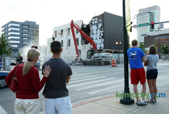 Mary Beth Navmann and Kevin Compton, left, and Brent Roach and Elizabeth Browning, watch members of the Diversified Demolition crew tear down the old Rite Aid building at the corner of Limestone and Main Street in Lexington July 23, 2008. The building was being demolished to make way for the proposed CentrePointe development. Photo by David Stephenson | Staff