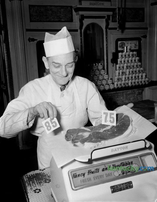 Henry Anderson, butcher at the New Sanitary Market at 124 North Broadway, was shown shifting a price tag on round steak from $.85 a pound to $.75 cents a pound on February 13, 1948. The drop in beef prices was attributed to a break in the grain and commonly markets. Today, $.75 would have the same buying power as $7.50. Published in the Lexington Herald February 14, 1948. Herald-Leader Archive Photo.