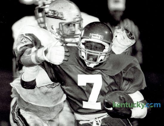 Lafayette High School quarterback Matthew Gay (7) fought off the grasp of a Boone County tackler on November 15, 1985. Lafayette downed the Rebels 34-7. The Generals kick off their season tonight, meeting Paul Laurence Dunbar in a neutral site at Scott County. Photo by David Perry | Staff