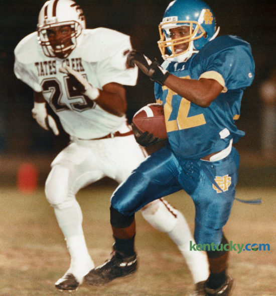 Henry Clay's Shawn Redmond (22) picked up 44 yards in the second quarter as Tates Creek's Kevin Jackson gave chase as the two city schools met on October 15, 1993 at Henry Clay High School. Henry Clay came out on top 14-7, thanks to a stingy defense. The Blue Devils take on Ryle High School in the Bluegrass Bowl tonight at Lexington Catholic. Photo by Janet Worne